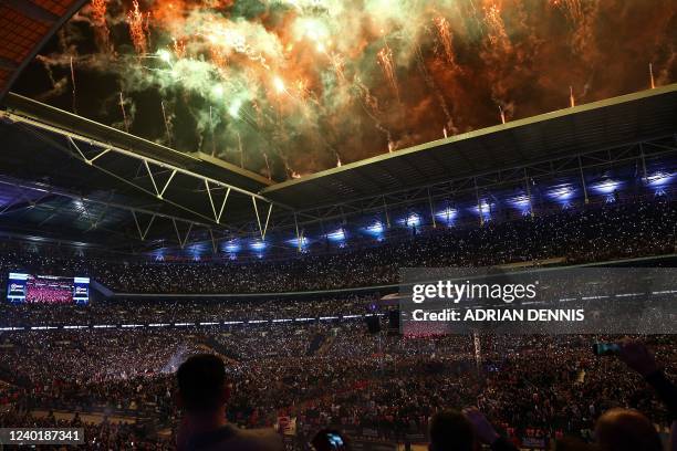 Fireworks explode as Britain's Tyson Fury and Britain's Dillian Whyte prepare to enter the ring for their WBC heavyweight title fight at Wembley...