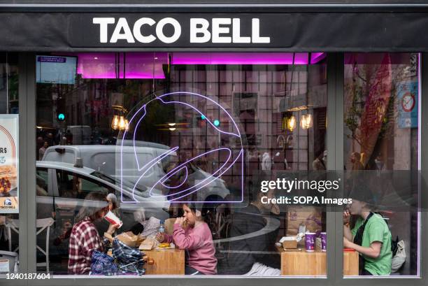 Customers eat at the American chain of fast-food restaurants Taco Bell in Spain.