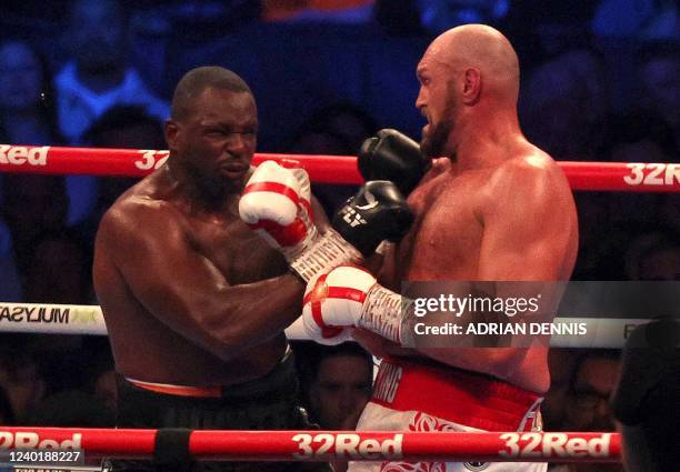 Britain's Tyson Fury lands a punch to knockout Britain's Dillian Whyte in the sixth round and win their WBC heavyweight title fight at Wembley...