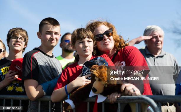 Woman and child look on as the National Anthem is sung during former US President Donald Trump's rally in Delaware, Ohio, on April 23, 2022.