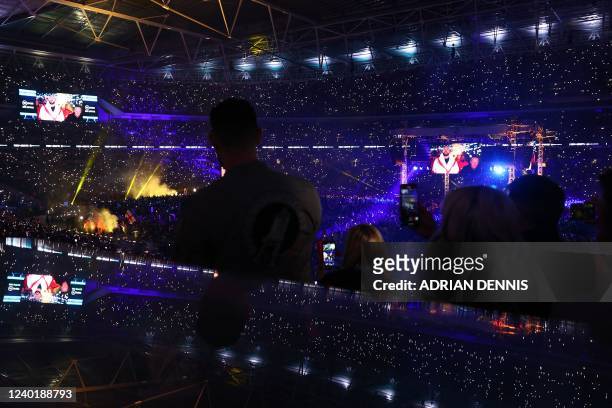 Fans cheer as Britain's Tyson Fury and Britain's Dillian Whyte prepare to enter the ring for their WBC heavyweight title fight at Wembley Stadium in...