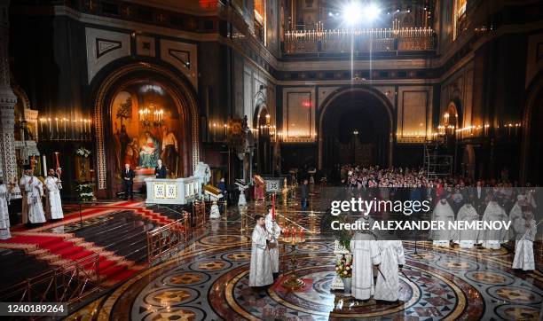 Russian President Vladimir Putin and Moscow Mayor Sergei Sobyanin attend an Orthodox Easter service, late on April 23, 2022 in Moscow.