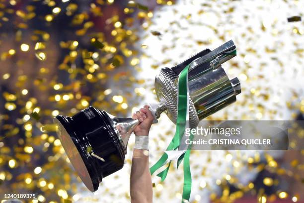 Real Betis' Spanish midfielder Joaquin raises the winner's trophy as he celebrates with teammates their victory after winning the Spanish Copa del...