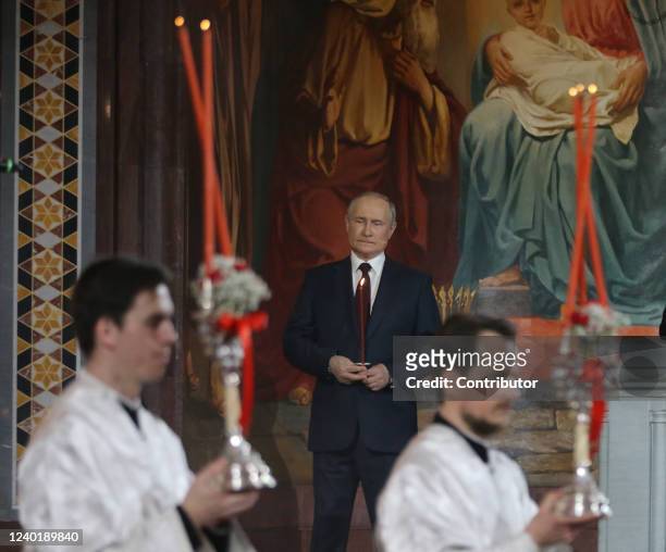 Russian President Vladimir Putin holds a candle during the Orthodox Easter mass led by Russian Orthodox Patriarch Kirill at the Christ The Saviour...