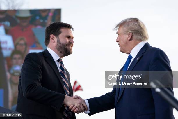 Vance, a Republican candidate for U.S. Senate in Ohio, shakes hands with former President Donald Trump during a rally hosted by the former president...