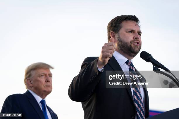 Former President Donald Trump listens as J.D. Vance, a Republican candidate for U.S. Senate in Ohio, speaks during a rally hosted by the former...