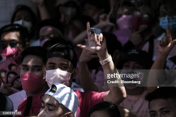 Supporter of Leni Robredo, Philippine vice president and presidential candidate, gestures during a campaign rally in Pasay City, the Philippines, on...