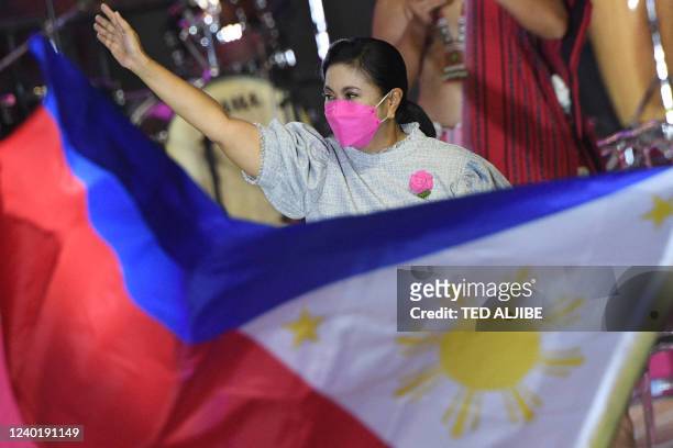 In this photo taken on April 23 Philippine Vice President and opposition presidential candidate Leni Robredo greets supporters during a campaign...