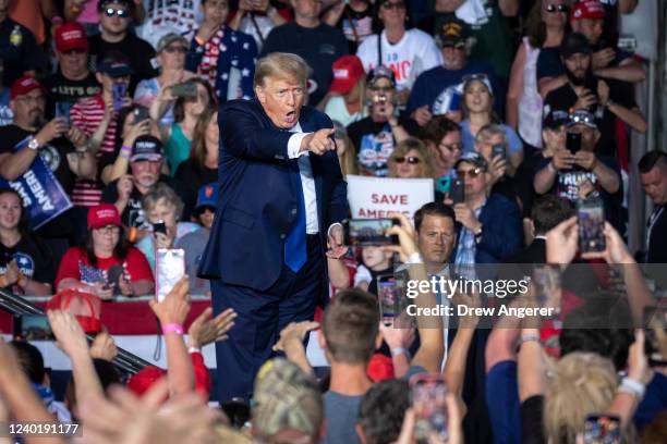 Former U.S. President Donald Trump exits the stage after speaking during a rally hosted by the former president at the Delaware County Fairgrounds on...