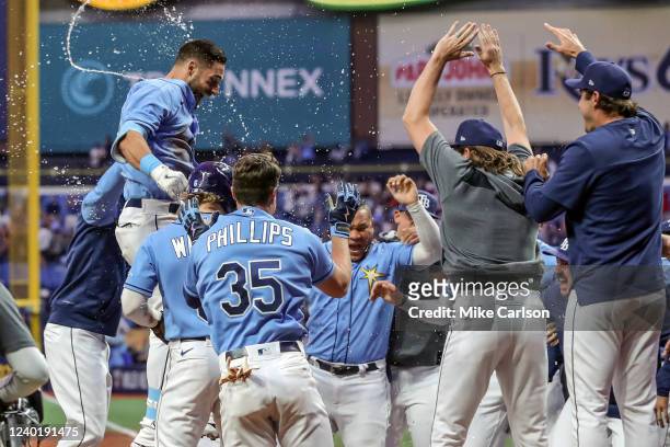 Kevin Kiermaier of the Tampa Bay Rays jumps to score on his game-winning home run against the Boston Red Sox during the 10th inning in a baseball...
