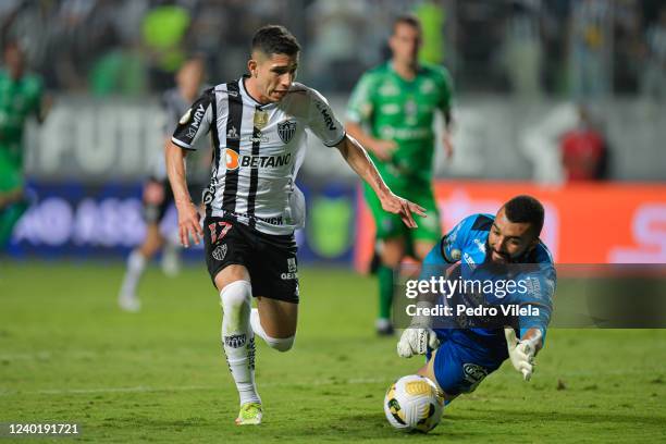 Savarino of Atletico Mineiro and Alex Muralha of Coritiba fight for the ball during a match between Atletico Mineiro and Coritiba as part of...