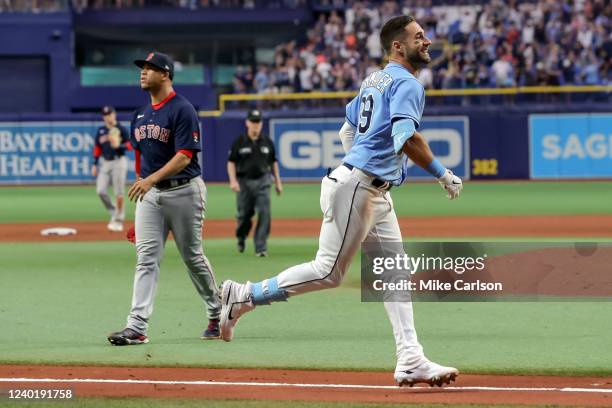 Kevin Kiermaier of the Tampa Bay Rays celebrates his game-winning home run in front of Hansel Robles of the Boston Red Sox during the 10th inning in...