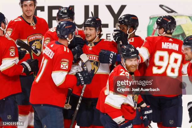 Teammates congratulate Brandon Montour of the Florida Panthers after he scored the winning goal in overtime against the Toronto Maple Leafs at the...