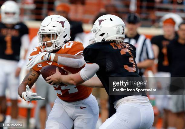 University of Texas Long Horns quarterback Quinn Ewers hands the ball off to running back Jonathan Brooks during the spring game on April 23 at...