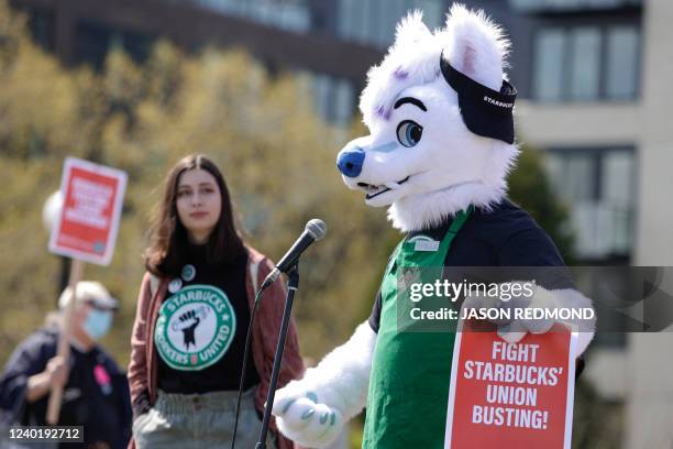 Michael Vestigo of Kansas City, Kansas, who claims he was fired by Starbucks, speaks while dressed as Apollo the wolf during the "Fight Starbucks'...