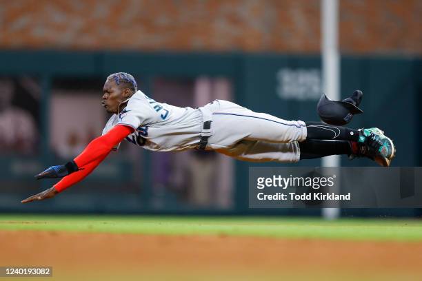 Jazz Chisholm Jr. #2 of the Miami Marlins dives into second base during the ninth inning of an MLB game against the Atlanta Braves at Truist Park on...