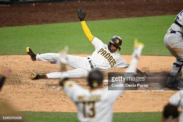 Manny Machado of the San Diego Padres celebrates as C.J. Abrams of the San Diego Padres scores during the 10th inning of a baseball game against the...