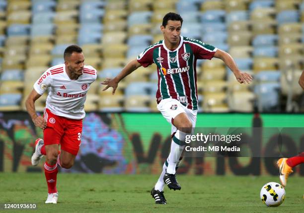 Paulo Henrique Ganso of Fluminense competes for the ball with Rene Martins of Internacional ,during the match between Fluminense and Internacional as...