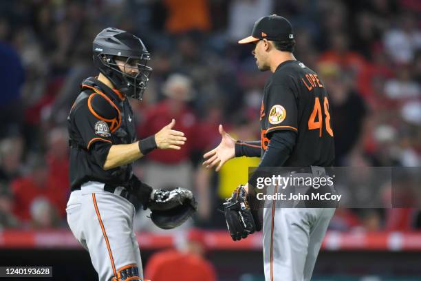Anthony Bemboom of the Baltimore Orioles congratulates Jorge Lopez after the defeated they Los Angeles Angels at Angel Stadium of Anaheim on April...