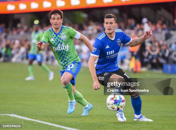 San Jose Earthquakes defender Nathan moves the ball away from Seattle Sounders midfielder Nicolás Lodeiro during the match between the Seattle...