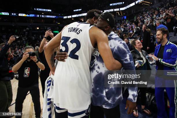 Karl-Anthony Towns of the Minnesota Timberwolves hugs his father Karl-Anthony Towns Sr. Following a 119-118 victory against the Memphis Grizzlies...