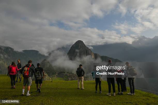 Tourists explore the ancient Inca city of Machu Picchu located in the Andes at an altitude of 2,430 meters . The most famous icon of the Inca...