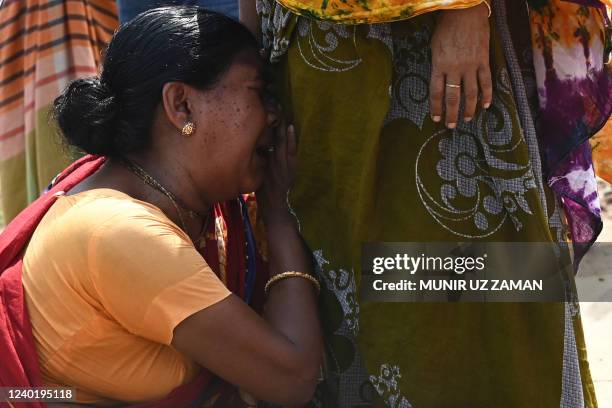 Relative of victim killed in the Rana Plaza building collapse reacts while marking the ninth anniversary of the disaster at the site where the...