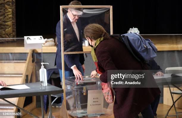 Citizen casts her ballot for the second round of France's presidential election at a polling station in Paris, France on April 24, 2022. Polling...