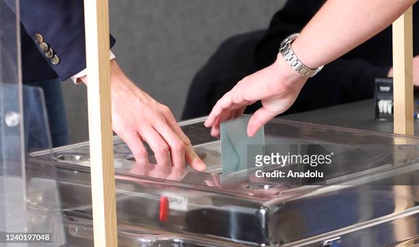 Citizen casts her ballot for the second round of France's presidential election at a polling station in Paris, France on April 24, 2022. Polling...