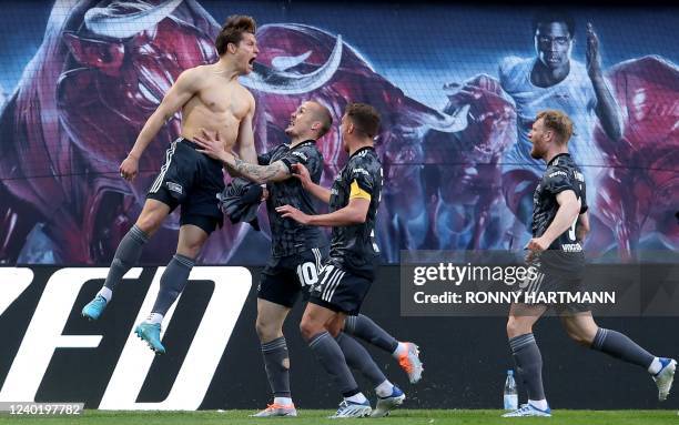 Union Berlin's German forward Kevin Behrens celebrates scoring the 1-2 with German forward Sven Michel, German midfielder Grischa Proemel and German...