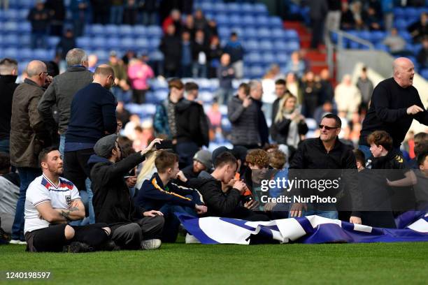 Fans on the pitch after the invasion during the Sky Bet League 2 match between Oldham Athletic and Salford City at Boundary Park, Oldham on Saturday...