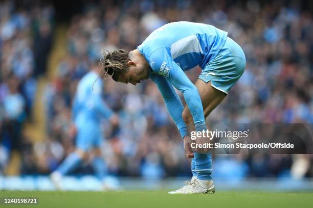 Jack Grealish of Manchester City adjusts his socks during the Premier League match between Manchester City and Watford at Etihad Stadium on April 23,...