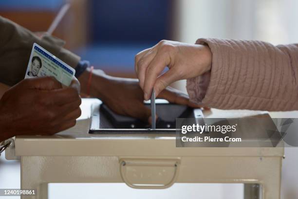 French citizen casts her ballot in a voting station located in Hotel de Ville, the city hall of Saint Denis on April 24, 2022 in Saint-Denis, France....