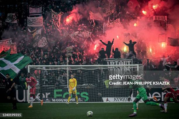 Saint-Etienne supporters light flares and let off fireworks during the French L1 football match between Saint-Etienne and AS Monaco at The Geoffroy...