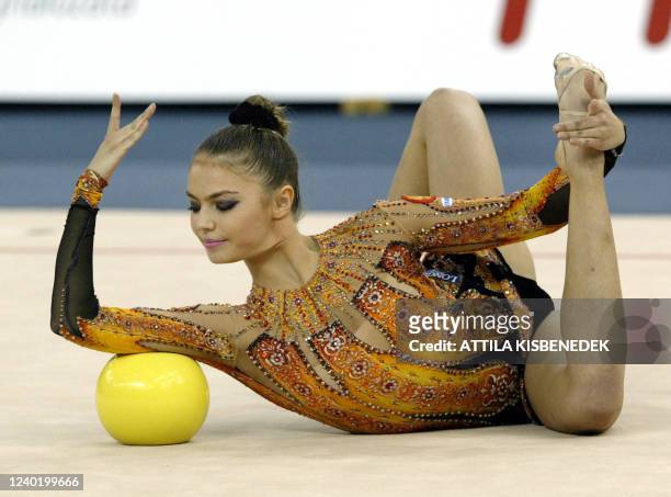 On her way for gold medal, Russian competitor Alina Kabaeva presents her exercise in hoop category of individual competition in 'Budapest Arena' on...