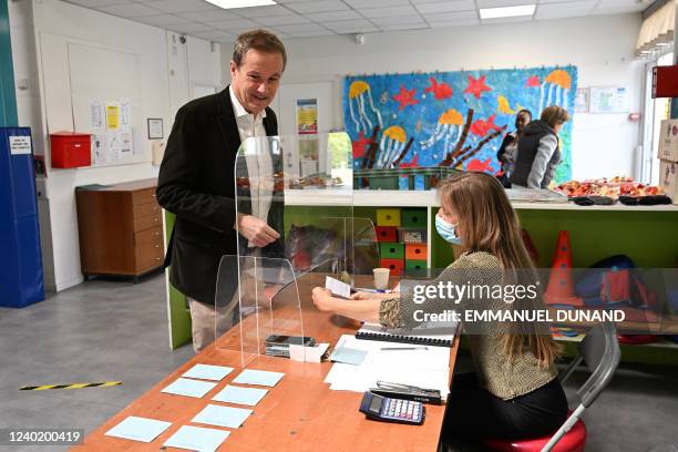 French far-right party Debout La France president and former presidential candidate Nicolas Dupont-Aignan has his electoral card being checked by an...