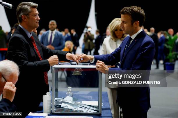 French President Emmanuel Macron, candidate for his re-election, votes for the second round of France's presidential election at a polling station in...
