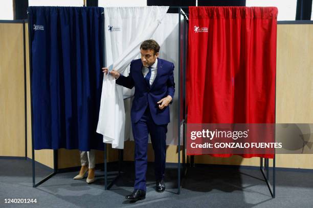 French President Emmanuel Macron, candidate for his re-election, leaves the voting booth for the second round of France's presidential election at a...