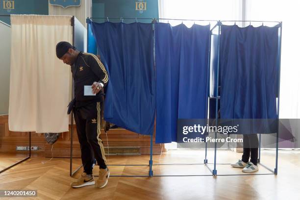 French citizen casts his ballot in a voting station located in Hotel de Ville, the city hall of Saint Denis on April 24, 2022 in Saint-Denis, France....