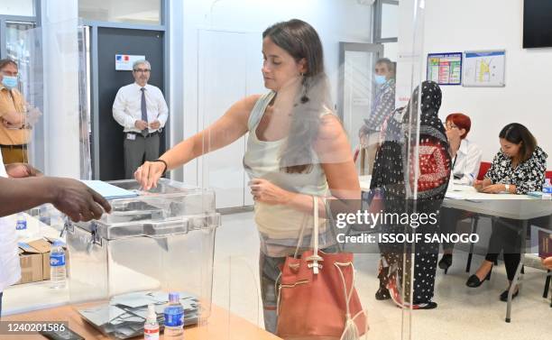 French nationals cast their ballots as they vote in the second round of French presidential elections, at a polling station in the Consulate General...