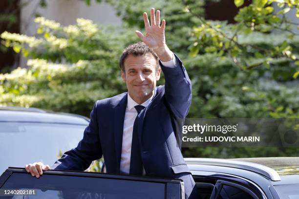 France's President and LREM party presidential candidate Emmanuel Macron waves at wellwishers as he leaves after voting for the second round of...