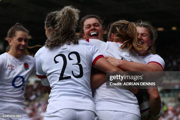 England's wing Lydia Thompson celebrates with teammates after scoring a try during the Six Nations international women's rugby union match between...