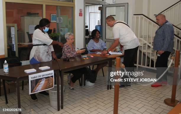 French citizen wait to cast their ballots in France's second round of Presidential elections at a voting station at the French consulate in downtown...