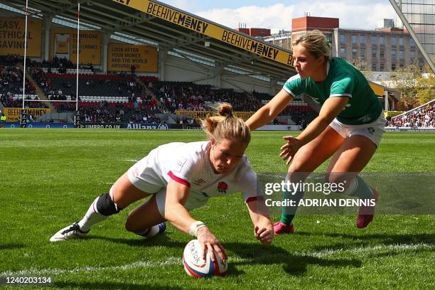 England's wing Lydia Thompson dives over the line to score a try during the Six Nations international women's rugby union match between England and...