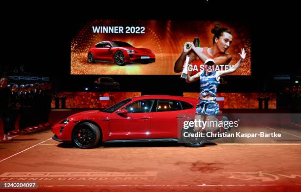 Iga Swiatek of Poland reacts during the trophy presentation as she beats Aryna Sabalenka of Belarus in their final match of the Porsche Tennis Grand...