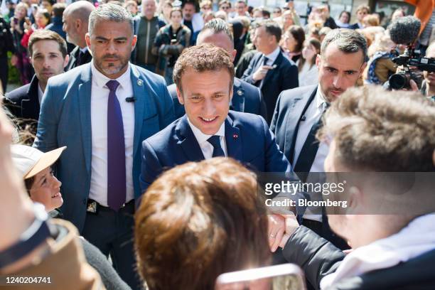Emmanuel Macron, France's president, greets members of the public ahead of voting during the second round of the French presidential election, in Le...