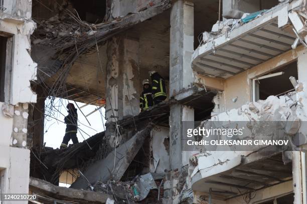 Rescuers clear debris in a damaged building in Odessa, southern Ukraine on April 24 which was reportedly hit by missile strike. - A Russian strike on...