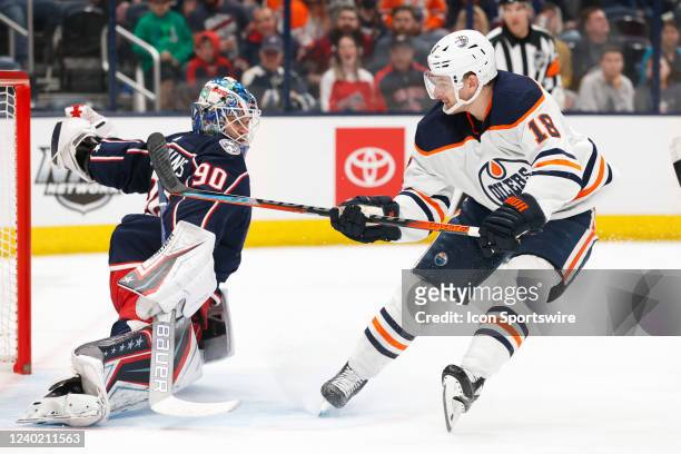 Edmonton Oilers left wing Zach Hyman attacks the goal defended by Columbus Blue Jackets goalie Elvis Merzlikins in the first period during the game...