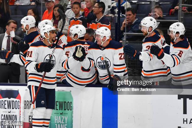 Evander Kane of the Edmonton Oilers high-fives his teammates after scoring a goal during the first period of a game against the Columbus Blue Jackets...