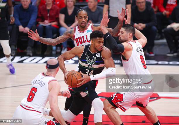 Milwaukee Bucks forward Giannis Antetokounmpo drives to the basket while being defended by Chicago Bulls center Nikola Vucevic during Game Four of...